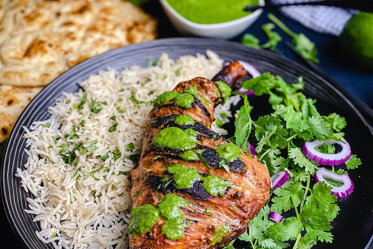 Grilled chicken with green herb sauce, rice and fresh coriander